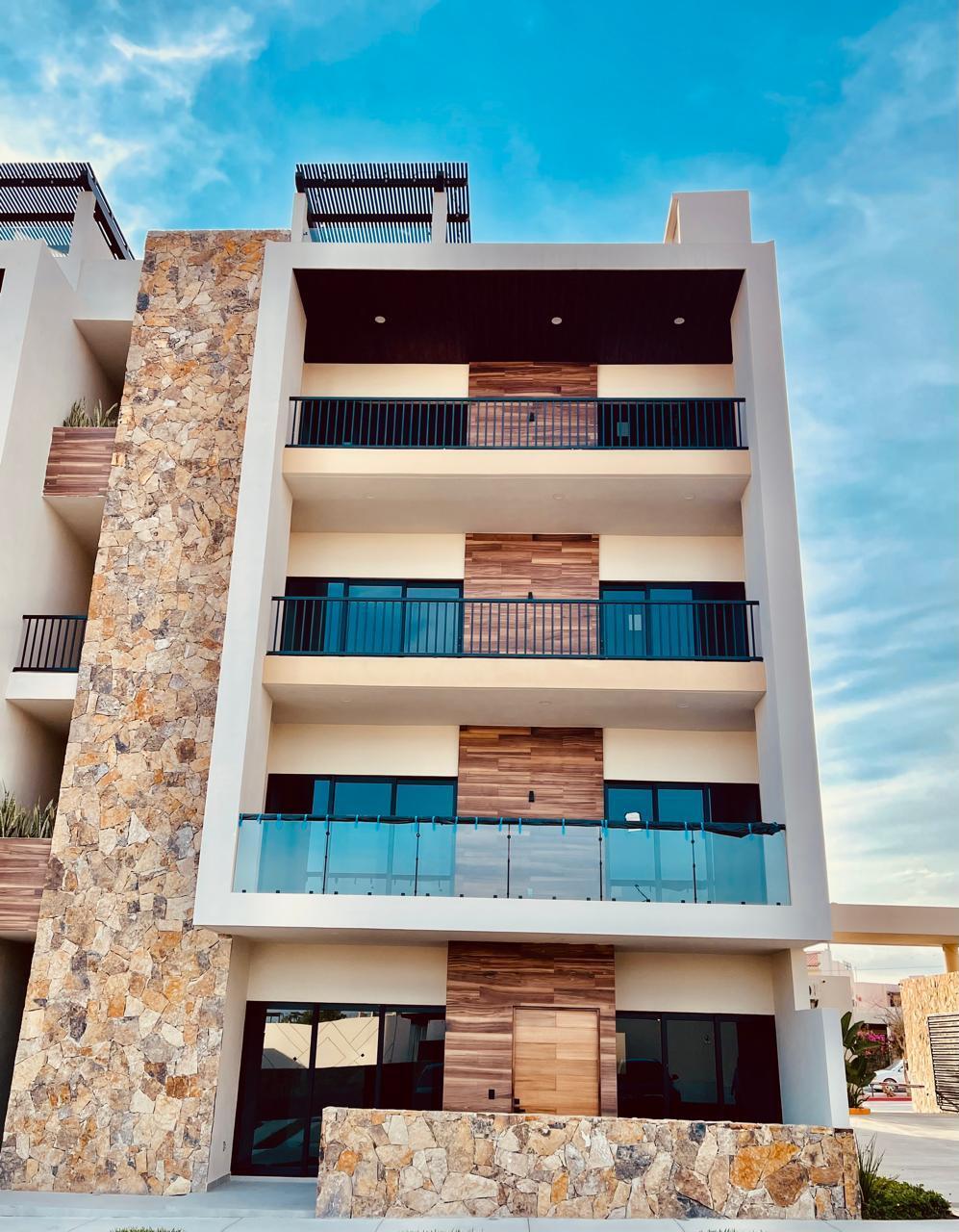 Cabo San Lucas Brisas Del Tezal Ready for immediate delivery! Beautiful ground-floor 2BR/2BA condo in Brisas del Tezal, an exclusive low-density community of only 36 residences in two 4-story elevator buildings. Just minutes from Medano Beach, downtown Cabo, shopping, golf, and restaurants. Features premium finishes including marble floors, granite countertops, parota wood carpentry, floor-to-ceiling marble showers, pantry, laundry room, wall-to-wall closets, mini-split A/C throughout, and a spacious terrace. No adjoining side neighbors for exceptional privacy. Resort-style amenities include a heated pool, clubhouse, coworking space with Wi-Fi, BBQ area, playground, landscaped grounds, 24/7 security, and immediate occupancy. Ideal for full-time living, vacation use, or investment. – 2 bedroom Ground-Floor Close to the Pool, Cabo Corridor, BS